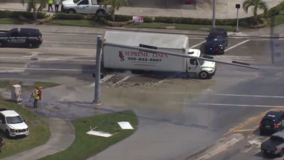Crews remove semi-truck that became stuck in Opa-locka sinkhole caused by water main break; driver OK